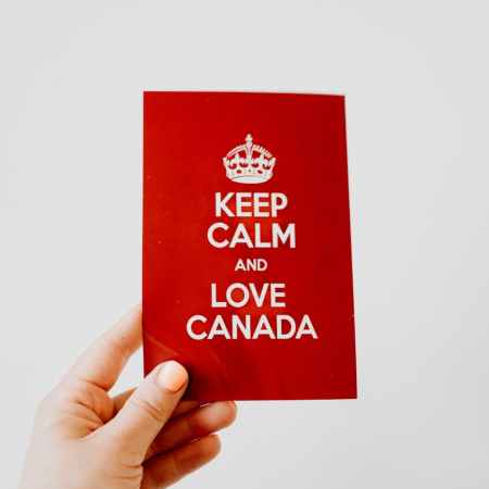 a hand holding a red card on a white background