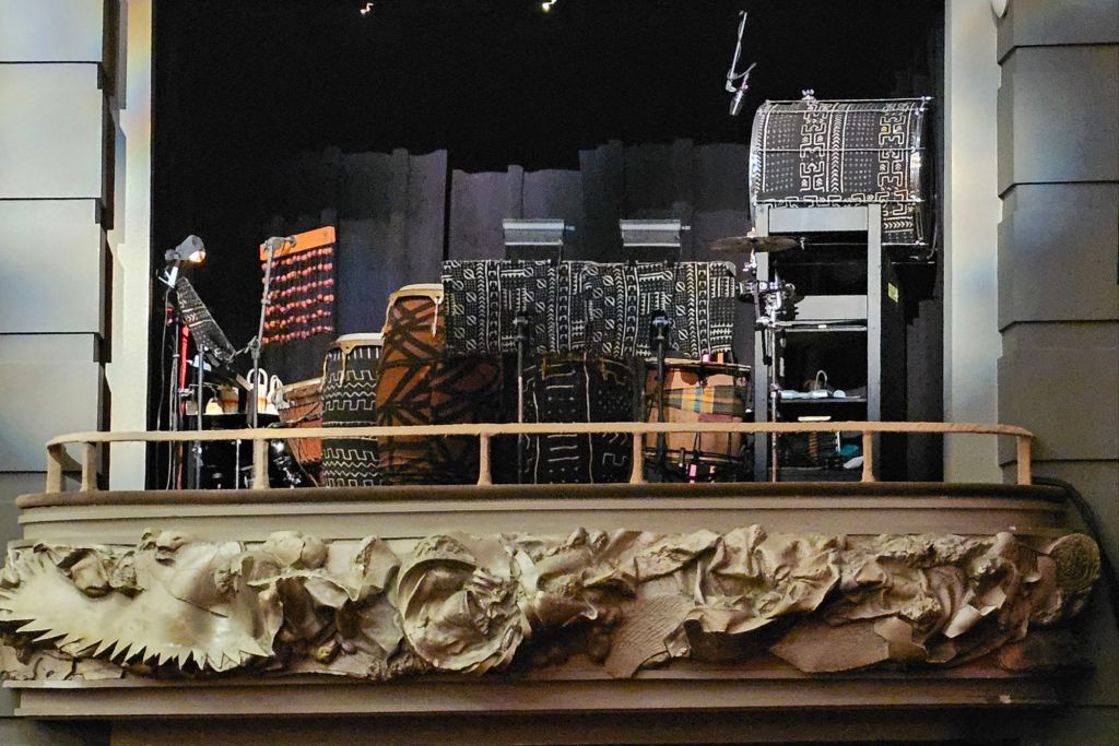 Stage setup for The Lion King production featuring colorful instruments and decor, showcasing the vibrant atmosphere of the Princess of Wales Theatre.